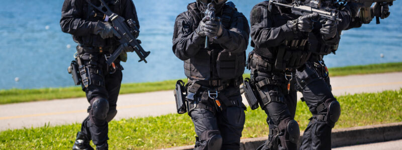 Special forces tactical team of four in action, unmarked and unrecognizable swat team